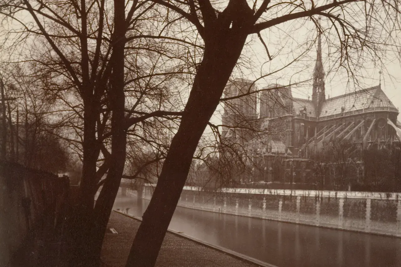 Paryż, zimowy widok na Sekwanę i Notre Dame, uchwycony przez Eugene'a Atgeta.